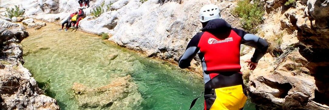 Marbella canyoning jumping into a rock pool